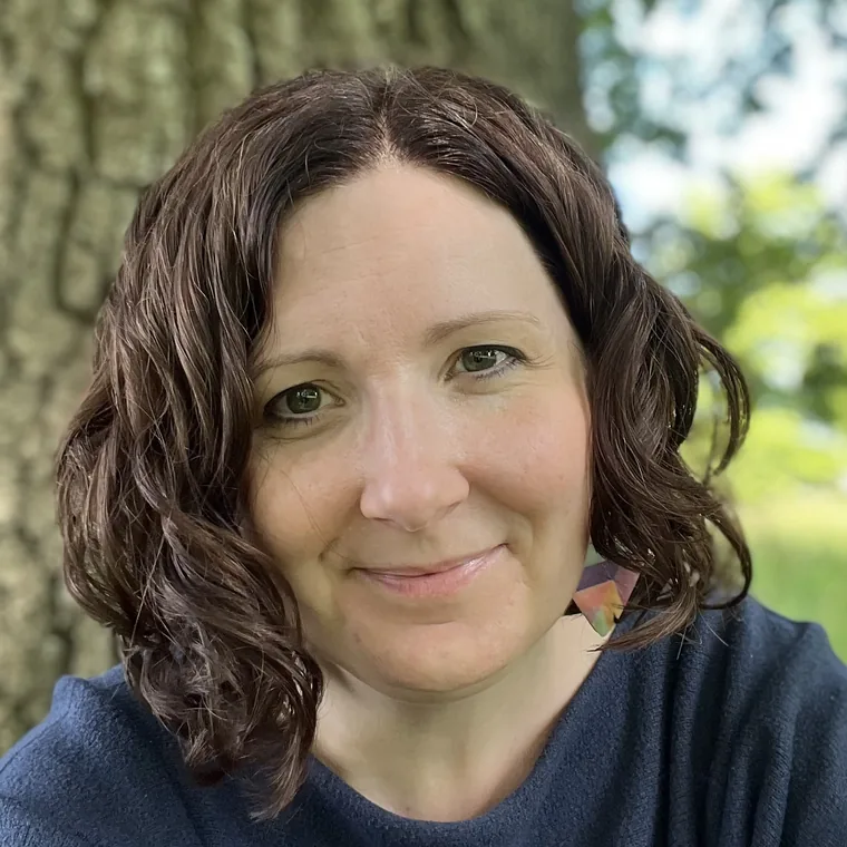 Anna Hobbs, integrative counsellor at Secoya Therapy, smiling outdoors among trees
