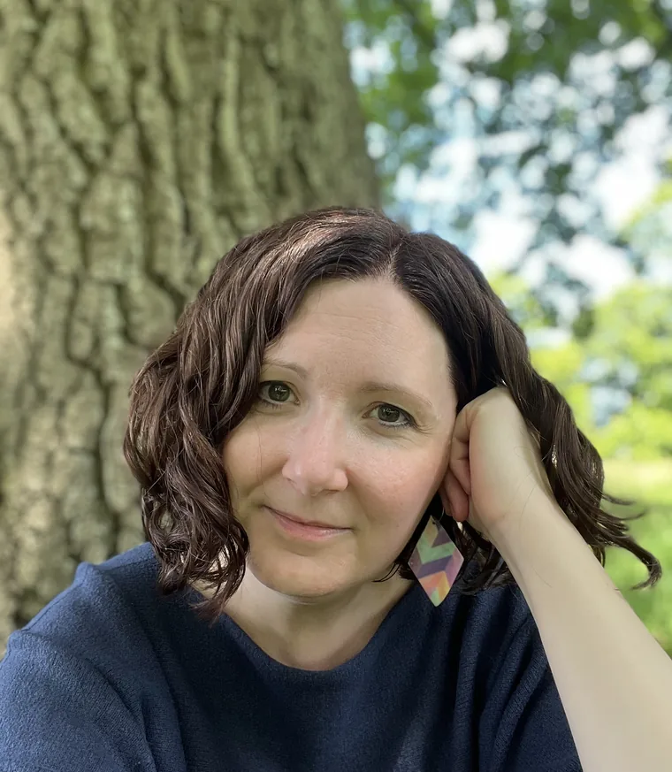 Anna Hobbs, integrative counsellor in East Kent, resting against a tree outdoors